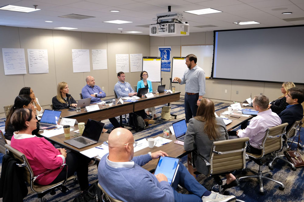 professor teaching students in a fuqua executive education classroom