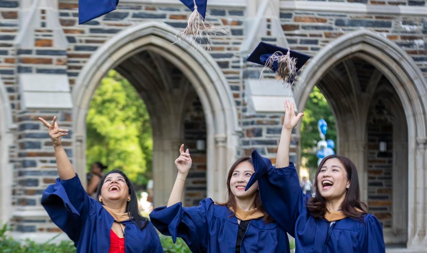 Graduates throwing their caps in the air