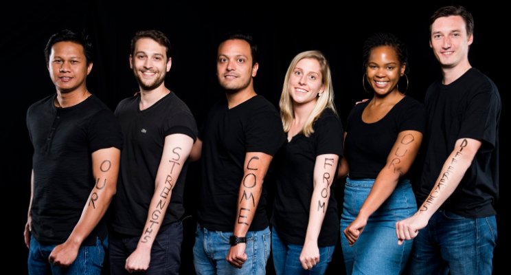 Six Fuqua students with diversity statements written on their arms