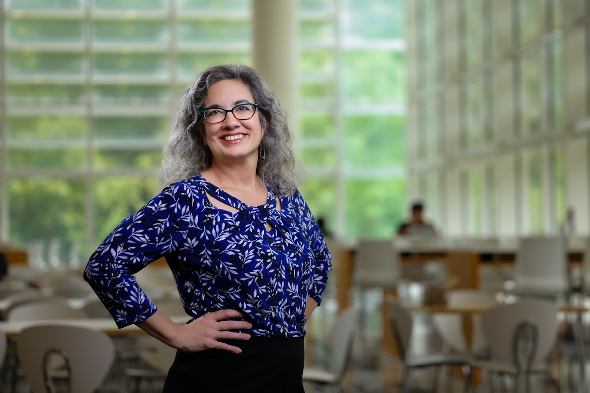 Interim Dean Mary Frances Luce standing in the library