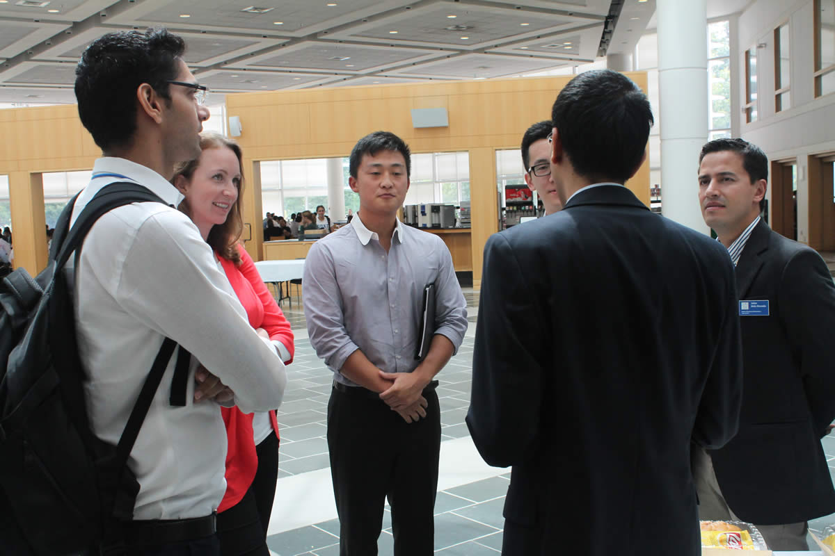 Students connecting with a company representative during the Finance Intensive