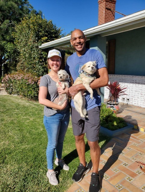 Katharene and husband with two rescue puppies